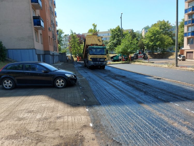 Elkezdődött az aszfaltozás a Ferenc körút 24–26. szám előtt, de sok esetben hátráltatják a munkát az ott parkoló autók